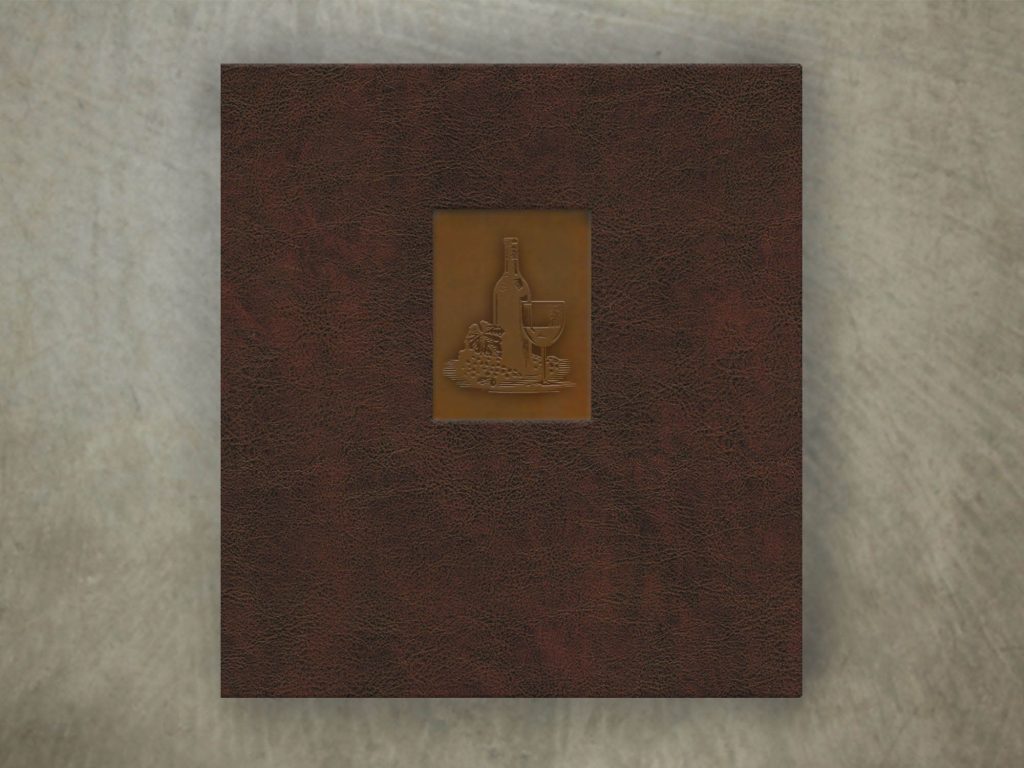 Brown leather menu with a patina copper underlay and an embossed logo of a wine glass and grapes