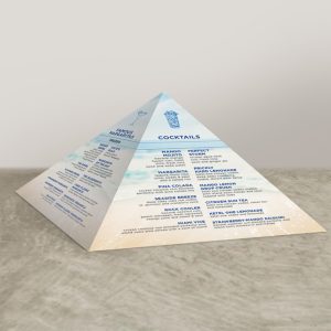 Pyramid table tent with beach themed graphics and blue and black text