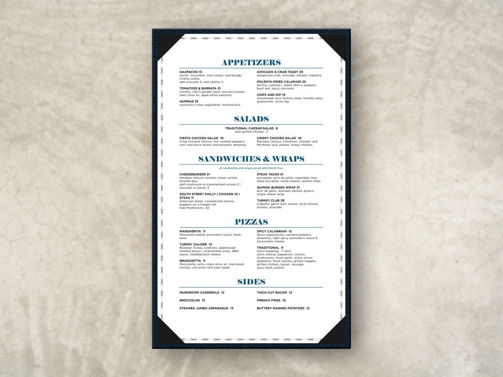 a white menu with black and blue text and a gray border held via corner pockets on a blue ostrich leather menu board